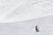 Snowboarder downhill on snowy ski trace