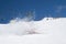 Snowboarder fall down with snow splashes on snowy ski slope