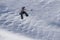 Snowboarder flying on the background of snowy slope. Extreme winter sports, snowboarding.