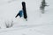 Snowboarder freerider jumping from a snow ramp on a background of forest and mountains