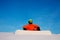 Snowboarder freerider with white snowboard sitting on the top of the ski slope