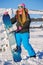 Snowboarder girl stands with snowboard.