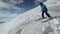 Snowboarder goes down and jump the mountain slope