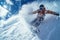 Snowboarder going down ski slope on snow background, man in mask rides snowboard spraying powder in winter. Concept of sport,