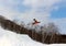 Snowboarder going off a big jump in hanazono park