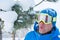 A snowboarder having fun, resting at a ski resort.