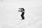 Snowboarder jump on snowy ski slope at winter mountains. Black and white toned image