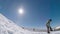 Snowboarder jumping against blue sky