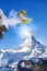 Snowboarder jumping against Matterhorn peak in Switzerland