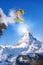 Snowboarder jumping against Matterhorn peak in Switzerland