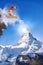 Snowboarder jumping against Matterhorn peak in Switzerland