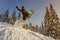 Snowboarder jumping through air with deep blue sky in background