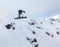 Snowboarder jumping in mountains