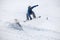 Snowboarder jumping on a snowy slope