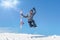 Snowboarder make fun and jump with snowboard in his hand