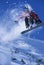 Snowboarder In Midair With Snow Powder Trailing Behind