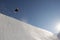 Snowboarder Performing Stunts In Park Against Blue Sky