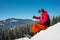 Snowboarder resting on top of the mountain