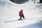 Snowboarder rides over fresh snow after jumping