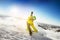 Snowboarder rides on the slope snow mountains background