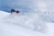 Snowboarder riding fast on dry snow freeride slope.