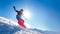 Snowboarder Riding Red Snowboard on the Slope in the Mountains in Bright Sun. Snowboarding and Winter Sports