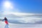 Snowboarder Riding Red Snowboard on the Slope in the Mountains in Bright Sun. Snowboarding and Winter Sports