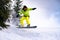 Snowboarder Riding Snowboard in the Forest at Cloudy Day. Snowboarding and Winter Sports