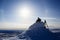 Snowboarder silhouette in the sunlight on top of the mountain