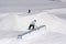 Snowboarder sliding on a box