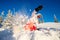 Snowboarder on snowboard rides through snow, explosion. Freeride snowboarding in Sheregesh Ski Resort