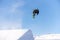 Snowboarder spinning doing a grab in the air