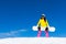 Snowboarder standing hold snowboard