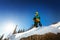 Snowboarder stands and looking far away