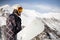 Snowboarder walking with a snowboard in the winter. Ski touring in the snowy mountains on a sunny day