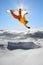 Snowboarders jumping against blue sky
