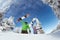 Snowboarders posing on blue sky backdrop in mountains
