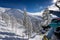 Snowboarders sitting on ropeway in mountains