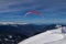 The snowboarders, skiers in action at the mountains.Paraglider with an instructor.