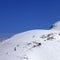 Snowboarders and skiers downhill on off piste slope at sun day