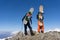 Snowboarders standing on top of a mountain