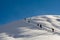 Snowboarders walking up the mountain