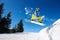 Snowboarding closeup in jump on blue sky background