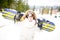 Snowboarding.Young beautiful woman with ski mask holding her snowboard at ski slope Young woman in ski resort