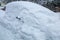 Snowbound car in the street, buried under a big snow layer