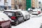 Snowbound cars parked at the roadside