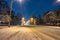 Snowbound city street at night