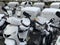 A snowbound motorcycles stands at the edge of a walkway.