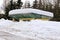 Snowbound unused bus stop building with heavy snowdrift