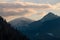 Snowcap mountains against cloudy sunset sky background